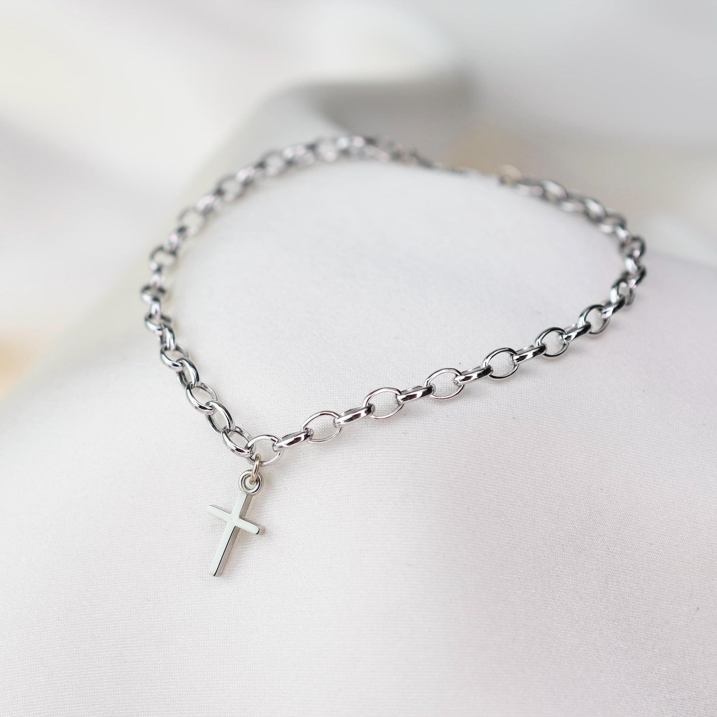 This elegant 14K white gold cross bracelet features a delicate 3.2mm rolo chain and a small cross charm, creating a timeless piece that symbolizes faith and style.