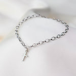 This elegant 14K white gold cross bracelet features a delicate 3.2mm rolo chain and a small cross charm, creating a timeless piece that symbolizes faith and style.