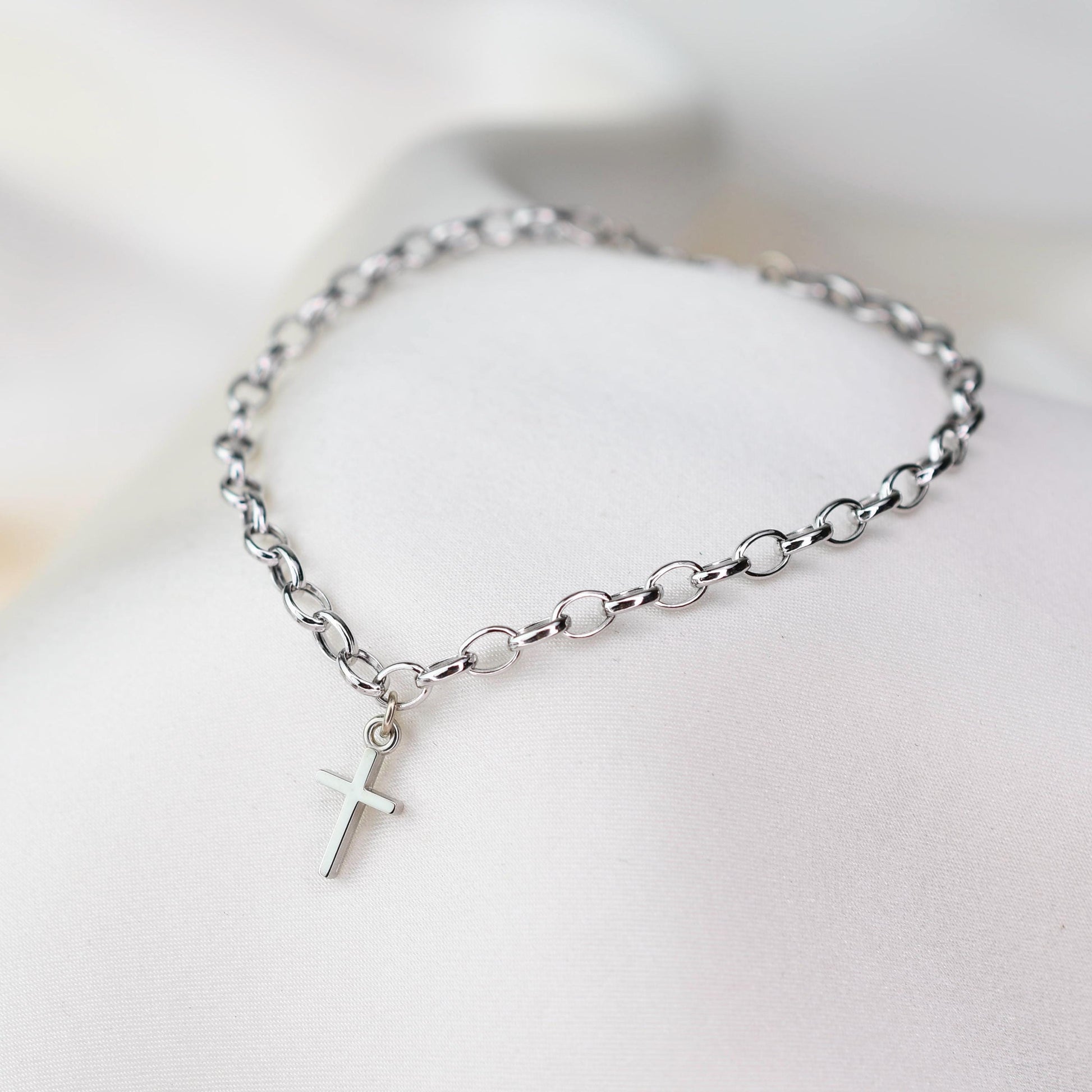 This elegant 14K white gold cross bracelet features a delicate 3.2mm rolo chain and a small cross charm, creating a timeless piece that symbolizes faith and style.