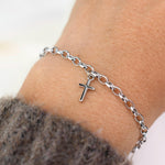 This elegant 14K white gold cross bracelet features a delicate 3.2mm rolo chain and a small cross charm, creating a timeless piece that symbolizes faith and style.