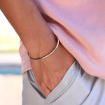 Close-up of a person wearing a gold bracelet 