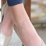14K gold delicate anklet by Sash Jewelry featuring a dainty solid gold chain with extension for adjustable fit.