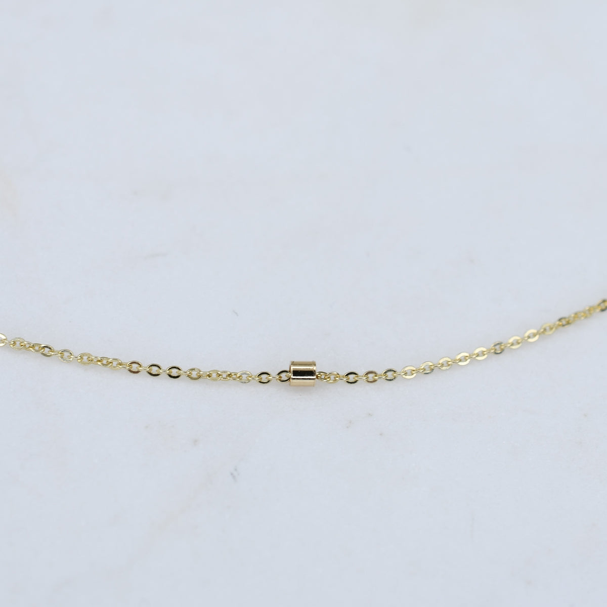14K gold dainty chain bracelet with 1.5mm beads from Sash Jewelry, featuring a thin, delicate gold chain design.