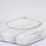 14K gold delicate anklet by Sash Jewelry featuring a dainty solid gold chain with extension for adjustable fit.
