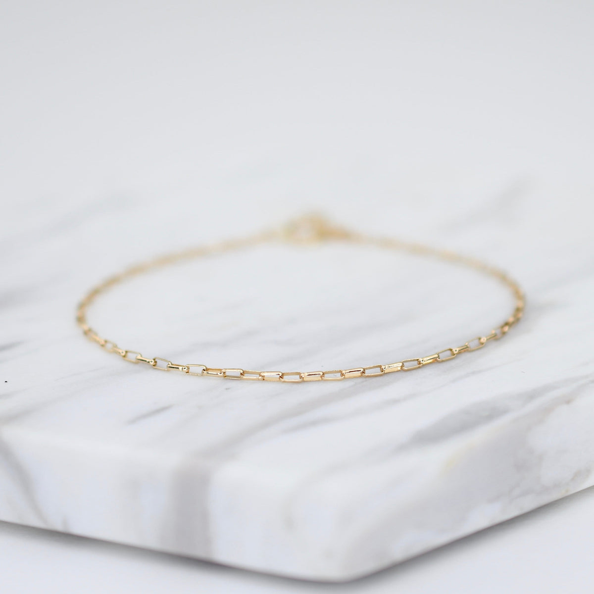 14K gold delicate anklet by Sash Jewelry featuring a dainty solid gold chain with extension for adjustable fit.