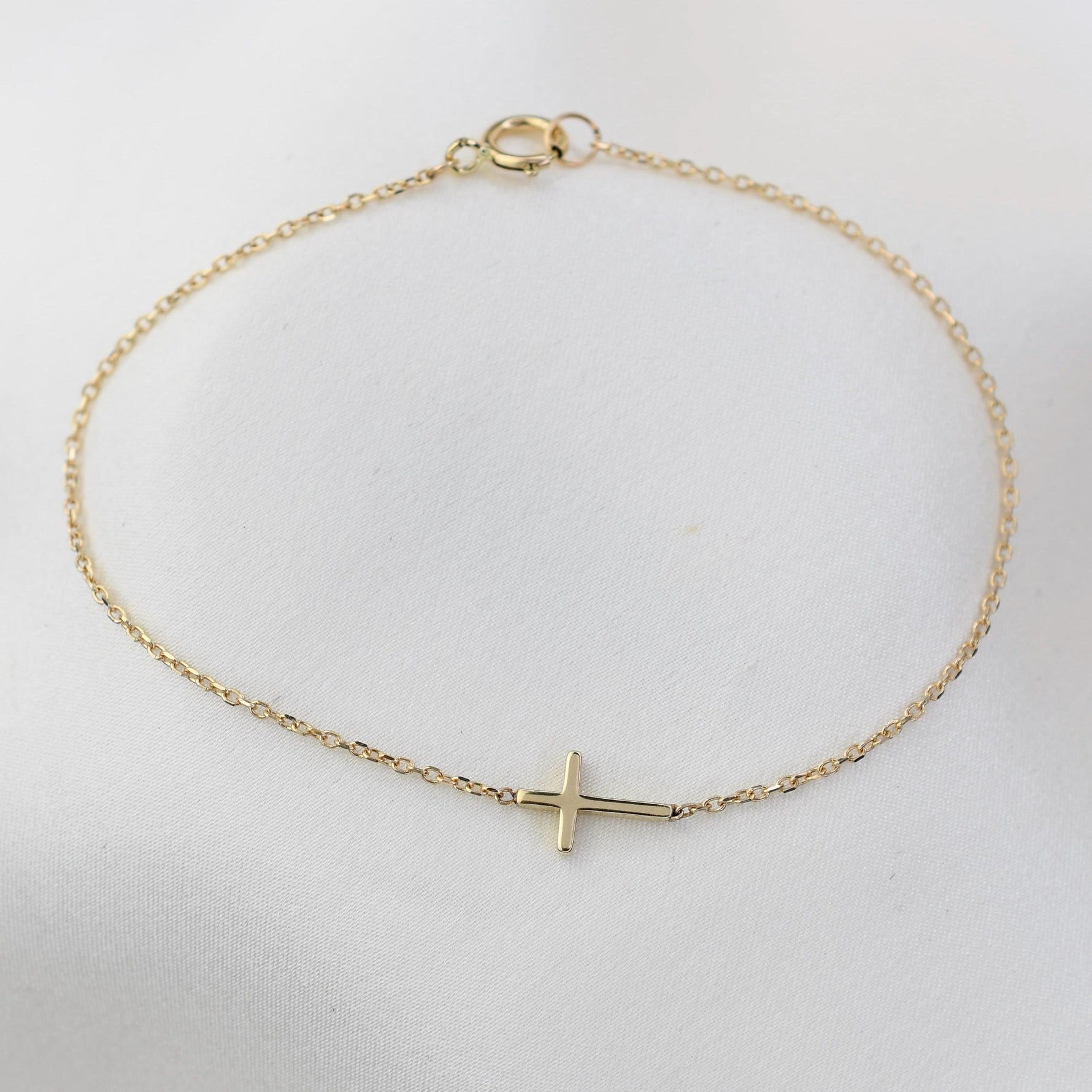 Faith-inspired 14K gold cross bracelet with fine chain