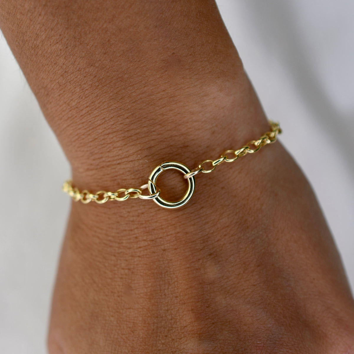 14K gold charm holder bracelet with rolo chain and hinged bail by Sash Jewelry, showcasing a sleek, elegant jewelry design.