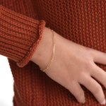 Minimal 14K solid gold paper clip chain bracelet close up