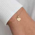 14K gold personalized heart charm bracelet with paper clip chain from Sash Jewelry, available in yellow and white gold.