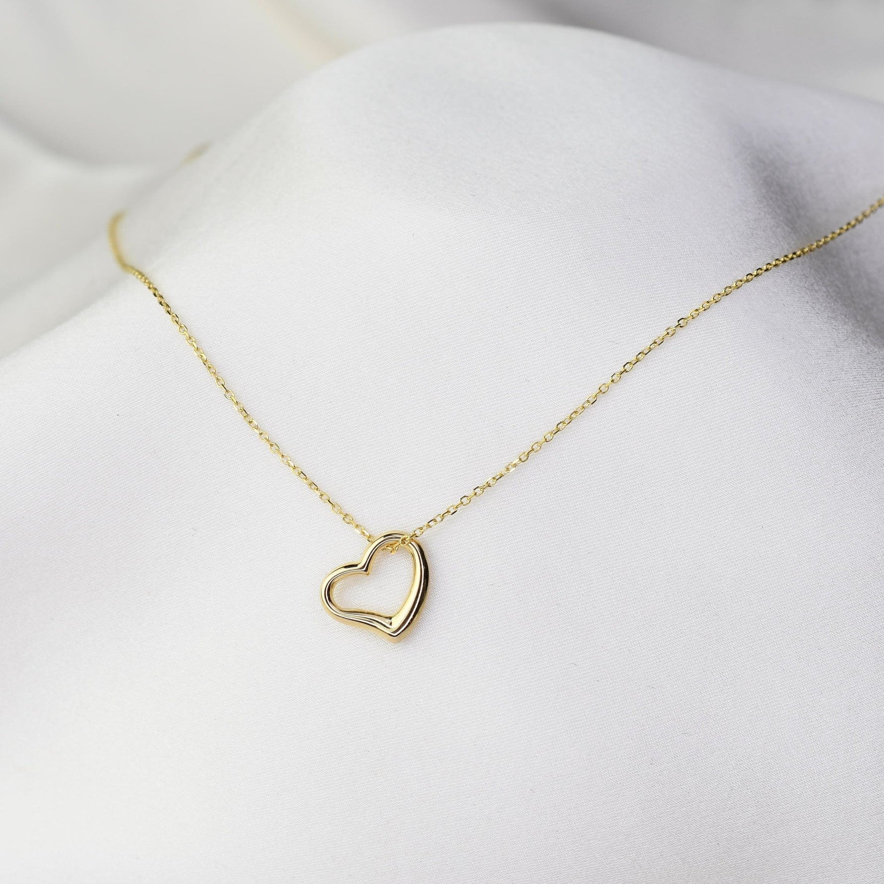 Minimal 14K gold heart charm necklace close up