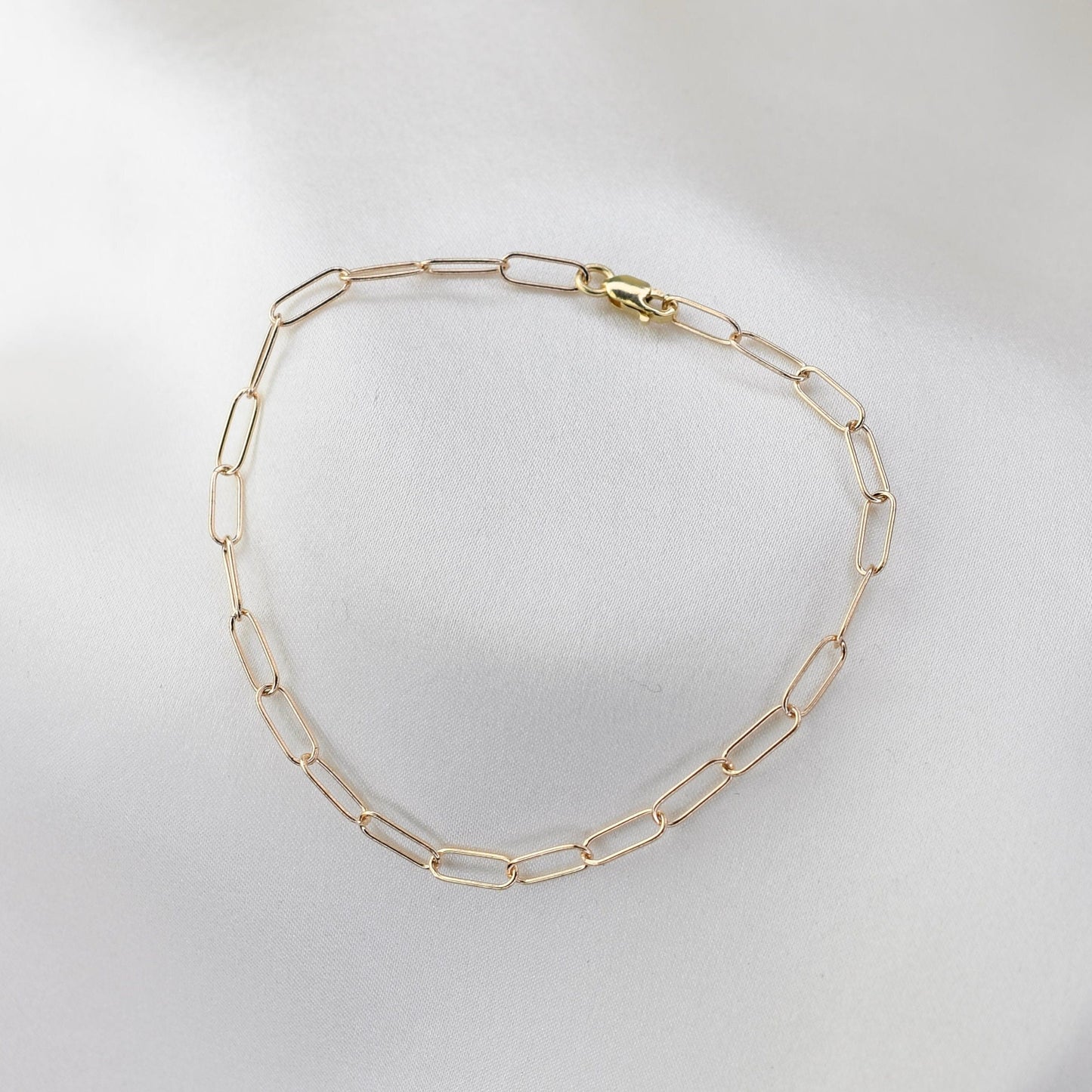 Minimalist 14K solid gold paper clip chain bracelet, 3mm wide. Perfect for everyday wear, stacking, or gifting. Durable, elegant, and timeless.