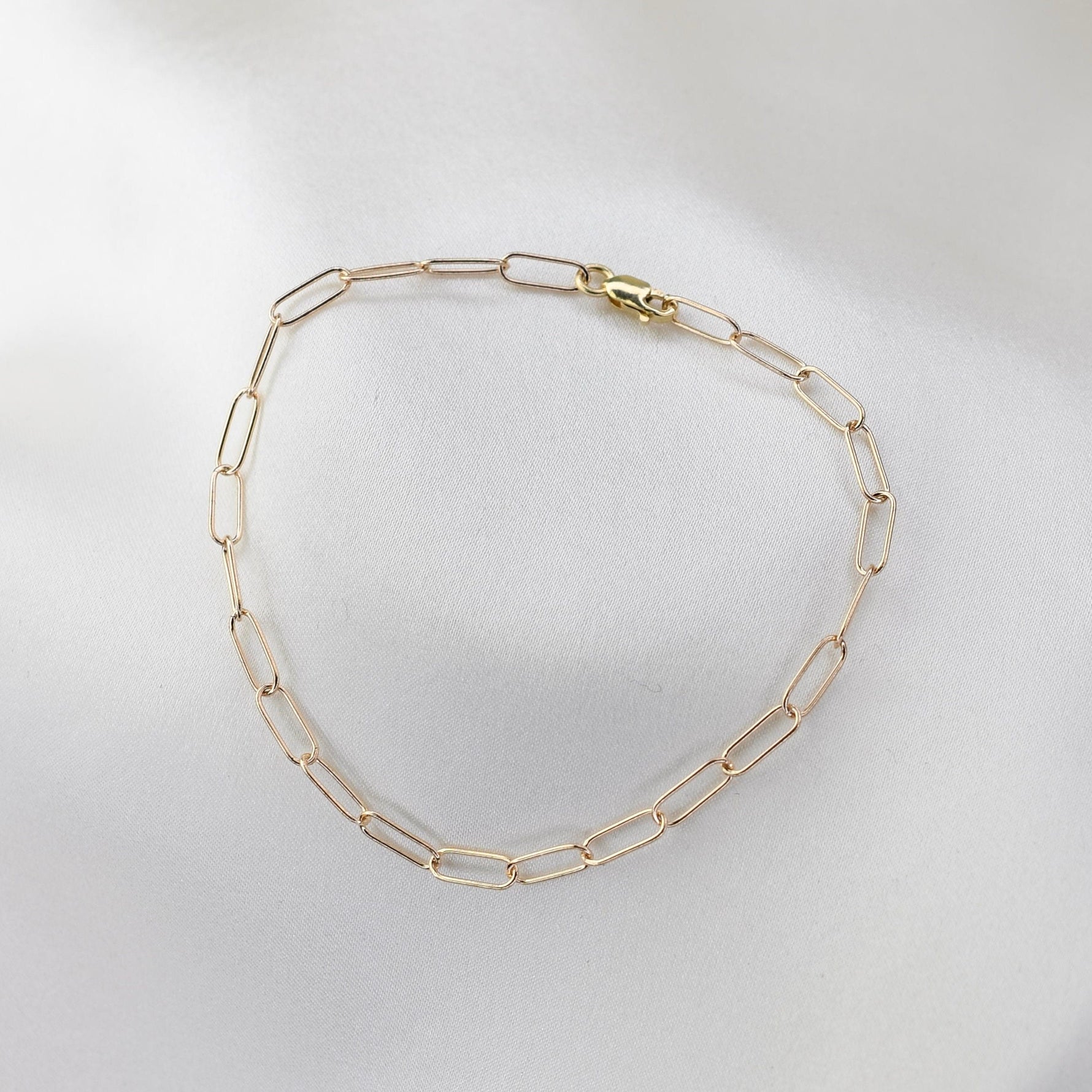 Minimalist 14K solid gold paper clip chain bracelet, 3mm wide. Perfect for everyday wear, stacking, or gifting. Durable, elegant, and timeless.