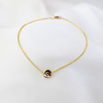 14K gold tiny initial bracelet with personalized letter charm from Sash Jewelry, showcasing a delicate gold bracelet with an initial pendant.