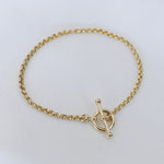 Minimal 14K gold rolo bracelet worn on wrist