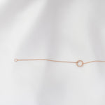 Rose gold bracelet on a light gray background