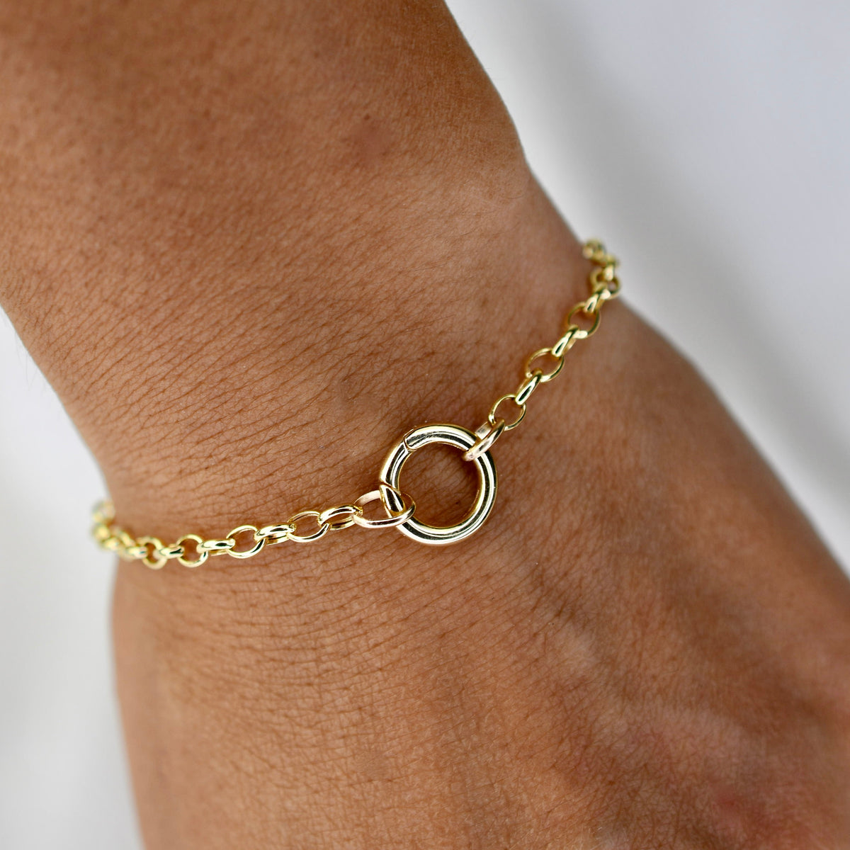 14K gold charm holder bracelet with rolo chain and hinged bail by Sash Jewelry, showcasing a sleek and elegant jewelry design