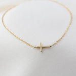 14K solid gold side cross bracelet on diamond-cut cable chain