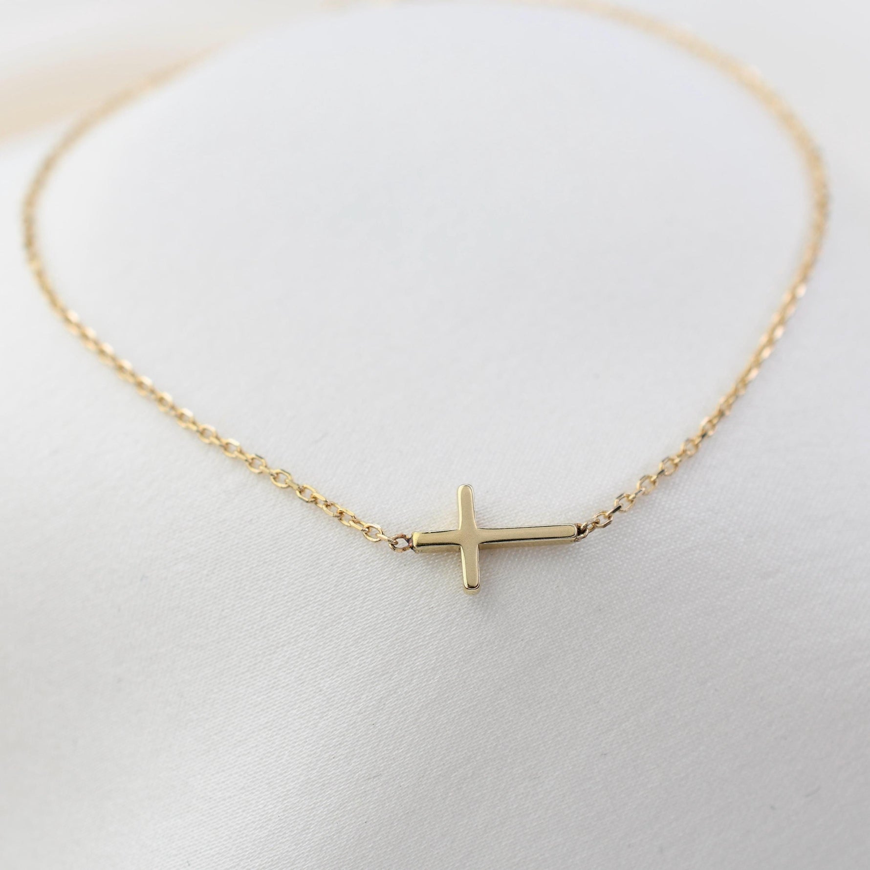 14K solid gold side cross bracelet on diamond-cut cable chain