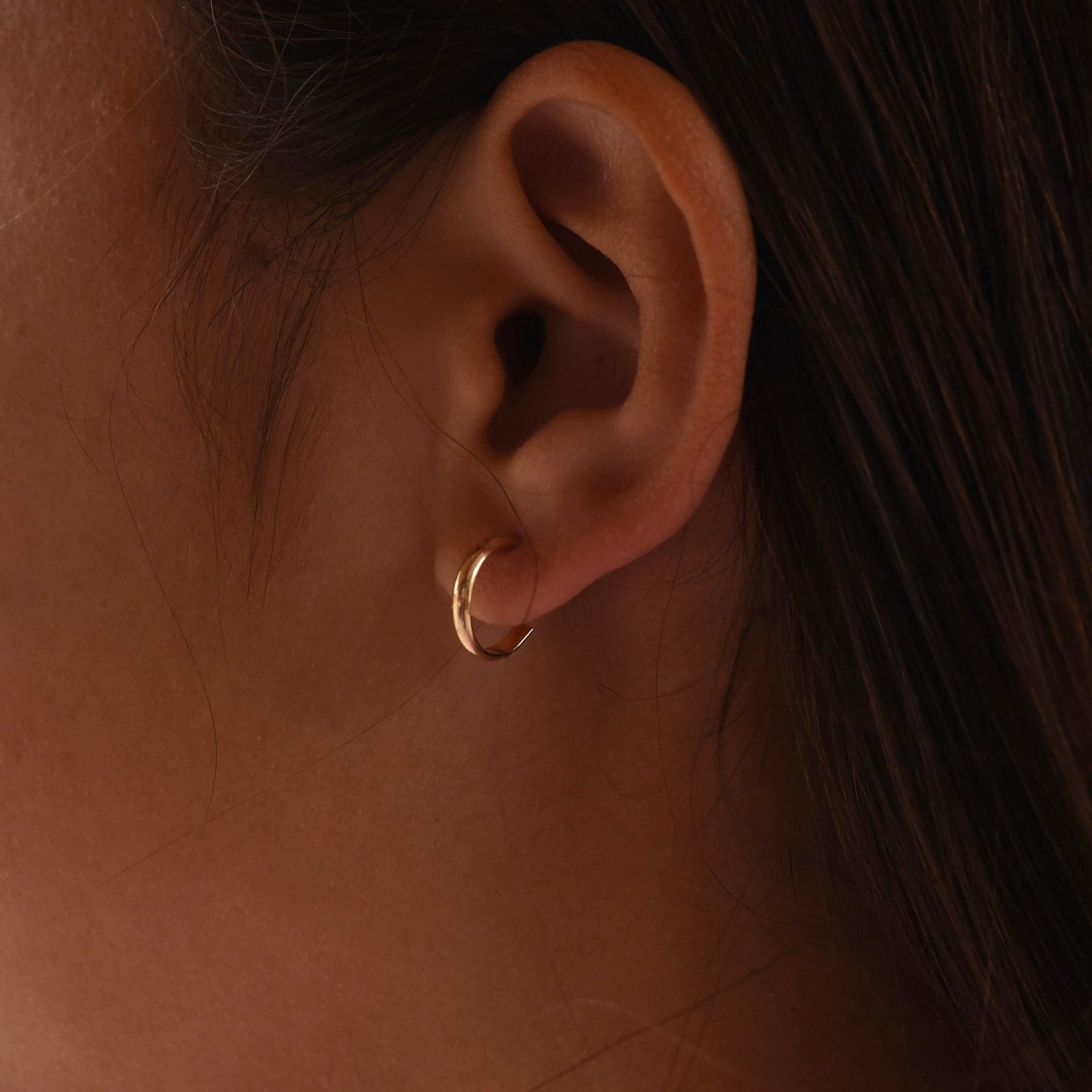 14K gold minimalist hoop earrings by Sash Jewelry, solid gold everyday earrings with a sleek, simple design.