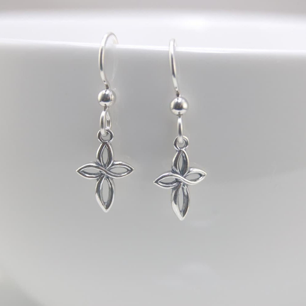 Silver cross-shaped earrings on a white background